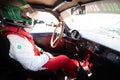 Vintage race car cockpit and dashboard, old Alfa Romeo with driver in racing suit