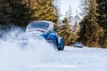 Vintage racing car drifting on classic rally snow covert road Royalty Free Stock Photo