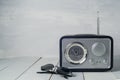 Vintage radio and sunglasses on wooden table Royalty Free Stock Photo