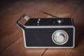 Vintage radio with a telescopic antenna on a wooden floor