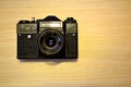 Vintage ragefinder camera on golden wooden background Royalty Free Stock Photo