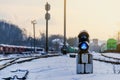 Vintage railway traffic light on an old snow covered railway station. Trains, rails, travel, abandoned