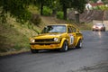 Vintage rally cars speeding across the city