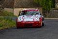 Vintage rally cars speeding across the city