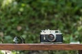Vintage rangefinder camera laying on a bench