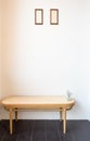 Vintage rattan chair with picture frame on the empty wall background Royalty Free Stock Photo