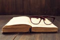 Vintage reading glasses on the open book Royalty Free Stock Photo