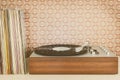 Vintage record player with record albums in front of seventies wallpaper Royalty Free Stock Photo