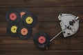 A vintage record player and five vinyl discs on a wooden table. Royalty Free Stock Photo