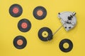 Vintage record player with multi-colored vinyl discs on a yellow background. Royalty Free Stock Photo