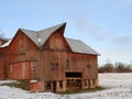 Vintage historic red timberframe barn showing joined roofs