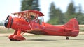Vintage red biplane takes off from a grass airfield. Panning picture. Royalty Free Stock Photo