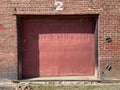 Vintage red brick wall building background red dock door Royalty Free Stock Photo