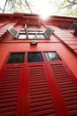 Vintage red building with wooden shutters