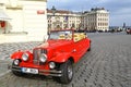 Vintage red car in front of Prague castle Royalty Free Stock Photo