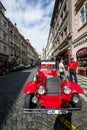 Vintage red car in front of Prague castle Royalty Free Stock Photo