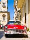 Vintage red car on a narrow street in Old Havana Royalty Free Stock Photo