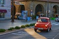 Vintage red car Zastava 750L slowly rides along the street of Koper. Front view. It produced