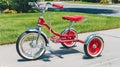 Vintage Red Tricycle on Sidewalk, Childhood Nostalgia, Sunny Day Outdoor Fun Royalty Free Stock Photo