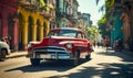 Vintage red classic car cruising on a sunny street in Havana with historical architecture and tropical vibes, capturing the Royalty Free Stock Photo