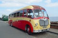 Vintage Red and Cream Bedford Super Vega Coach parked at the seaside.
