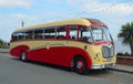 Vintage Red and Cream Bedford Super Vega Coach parked at the seaside.