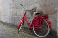 Vintage red Dutch bike parked by old city wall Royalty Free Stock Photo