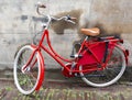 Vintage red Dutch bike parked by old city wall Royalty Free Stock Photo