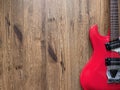 Vintage Red Electric guitar made from mahogany wood With a black and white pickguard, old brown wood background with copy space