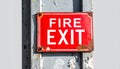 Vintage Red Fire Exit Sign on a Weathered Post Royalty Free Stock Photo