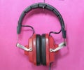 Vintage red headphone on pink background, podcast,recording sound,information concept. Free copy space.