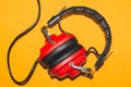 Vintage Red Headphones On Yellow Background. Classic Earphones