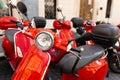Vintage red Italian moto on traditional street. A motor scooter on the sidewalk in the old town of Rome Royalty Free Stock Photo