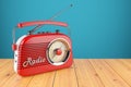 Vintage red radio receiver on wood table.