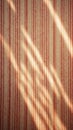 Vintage red striped wallpaper with sunlight patterns on textured surface Royalty Free Stock Photo