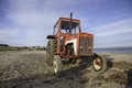 Vintage red tractor on the beach Royalty Free Stock Photo