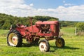 Vintage red tractor in landscape Royalty Free Stock Photo