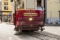 Vintage red tram going up ramps in the old city of Lisbon in Portugal