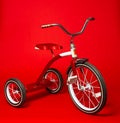 Vintage red tricycle on a bright red background Royalty Free Stock Photo