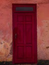 Vintage red wooden door. Antique building exterior detail. Street photo. Retro wood boards.Empty abstract grunge texture Royalty Free Stock Photo