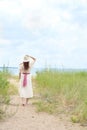 Vintage redhead woman holding her hat on the beach Royalty Free Stock Photo