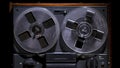 Vintage reel to reel tape recorder on black studio background. Retro music player with old plastic bobbins. Analog Royalty Free Stock Photo