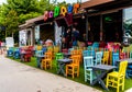 Vintage Restaurant Window With Colorful Chairs And Tables