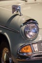 Vintage restored classic car close-up. Sealed-beam retro headlamp. Sixties headlight.