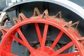 Closeup of red painted antique tractor wheel with steel cleats Royalty Free Stock Photo