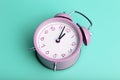 Vintage retro alarm clock on a blank colored minimal background. Time, clock, timing concept.