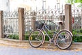 Vintage retro bicycle near metal iron fence. Outdoors. Royalty Free Stock Photo