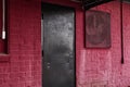 A vintage retro black steel painted door red brick wall and vent Royalty Free Stock Photo