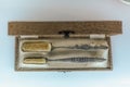 Vintage retro box view with old toothbrushes with ornate metal handles Royalty Free Stock Photo