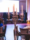 Vintage retro brass candlesticks with candles burning, luxury event banquet table setting decoration in a restaurant hall, Royalty Free Stock Photo